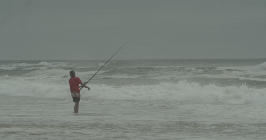 Man Fishing by the Sea