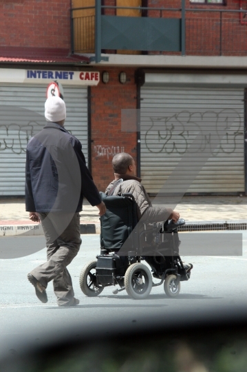 Man pushing wheelchair