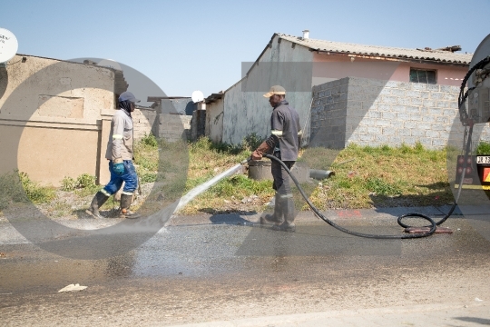 Municipal Workers washing the road