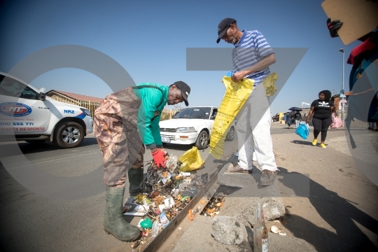 Worker Removing Garbage from road